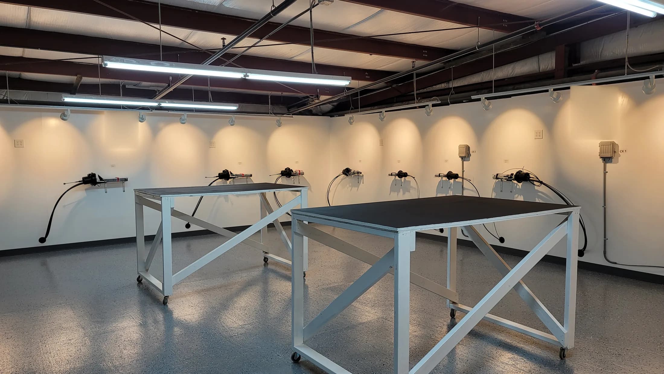 Issued lab still, 2021-02-10: working room with wall-mounted plant, benches on casters, wall lights on